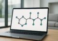 Laptop displaying a stylized molecular structure on a screen.